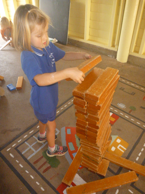 Student constructing wooden tower